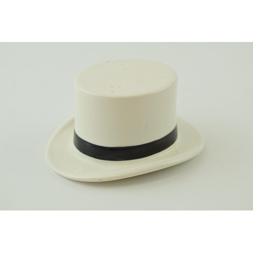 94 - F R Tripler & Co pottery top hat in white and black colours, 10.5cm long.