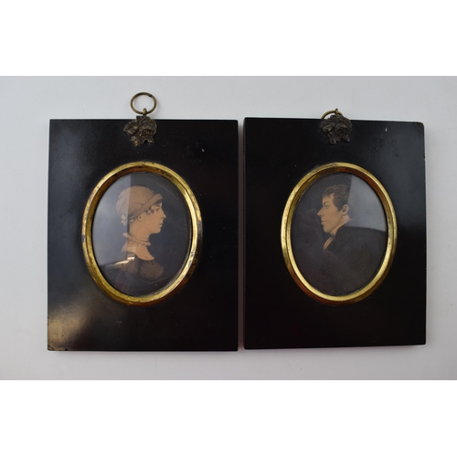 614 - A pair of framed miniatures, oval mounts, of a man and a lady, 13.5cm tall inc frames (2).