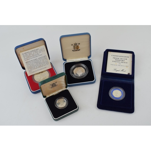 629 - Four cased sterling silver proof coins to include Piedfort Twenty Pence, a 50p, a pound coin and a c... 