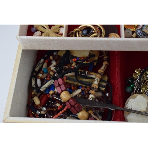 634 - A jewellery box containing a quantity of costume jewellery such as brooches, rings, necklaces and ot... 