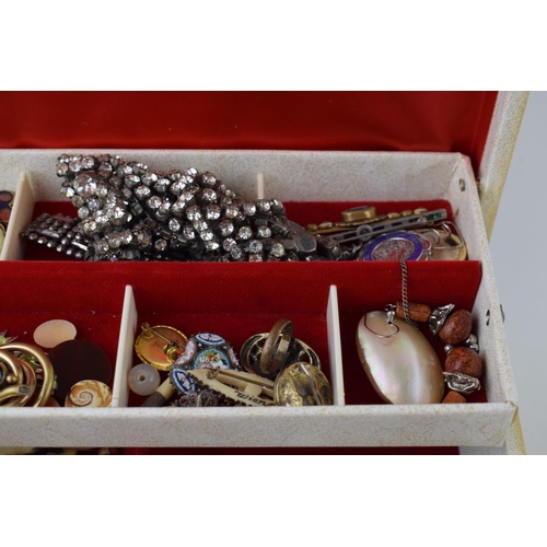 634 - A jewellery box containing a quantity of costume jewellery such as brooches, rings, necklaces and ot... 