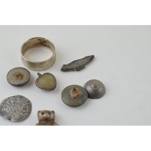 652 - A collection of metal detecting finds to include a silver teddy charm, a hammered silver coin, middl... 