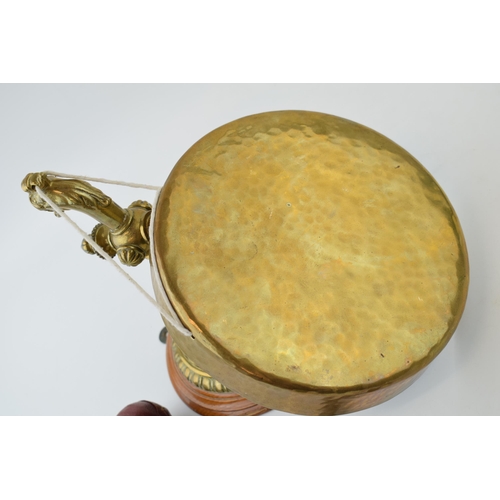 318 - Wall mounted brass dinner gong with leather ended striker, wooden mount, 21cm diameter of gong.