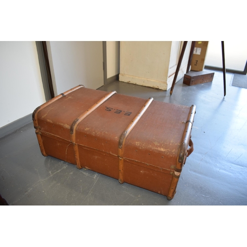 331 - A travel trunk with wooden banding and brass catches. Inner tray present and clean. Leather straps t... 