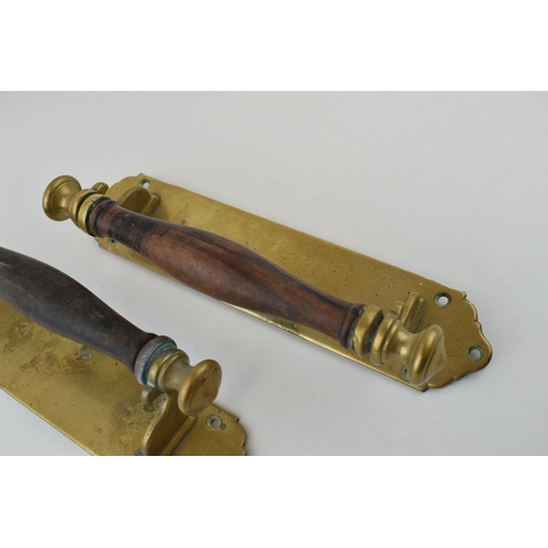 351 - A pair of brass door pulls with hardwood handles. Height 33cm.