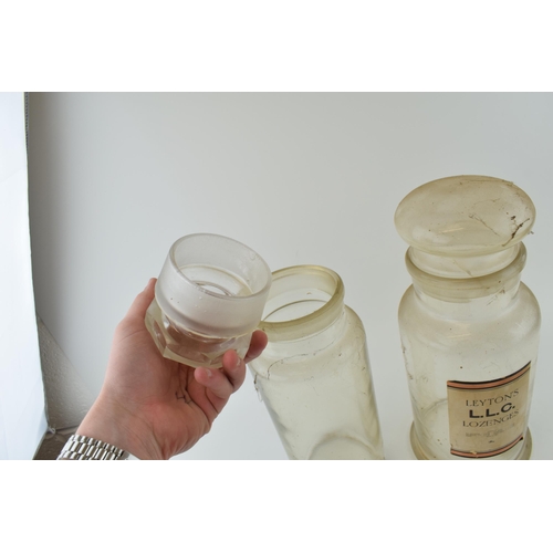 355 - A pair of large 20th century oversized glass chemist jars to include Leyton's LLC Lozenges and one s... 