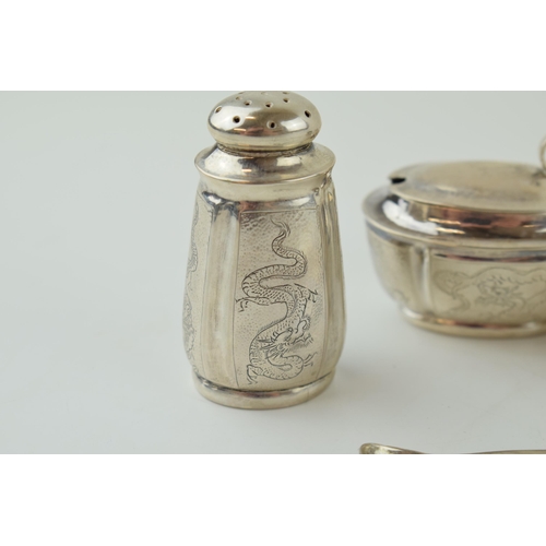 581 - Silver three piece cruet set, with glass liners, engraved, stamped 'silver 90', with associated plat... 