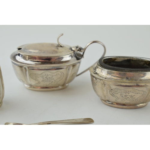 581 - Silver three piece cruet set, with glass liners, engraved, stamped 'silver 90', with associated plat... 