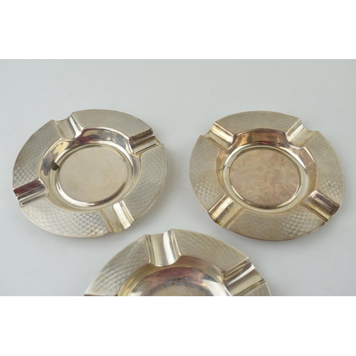 584 - A pair of silver ashtrays, engineered design, Birmingham 1933, 11.5cm wide, with a similar singular ... 