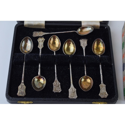 604 - A collection of Chinese silver items to include two sets of six spoons and a cruet set (one hinge af... 