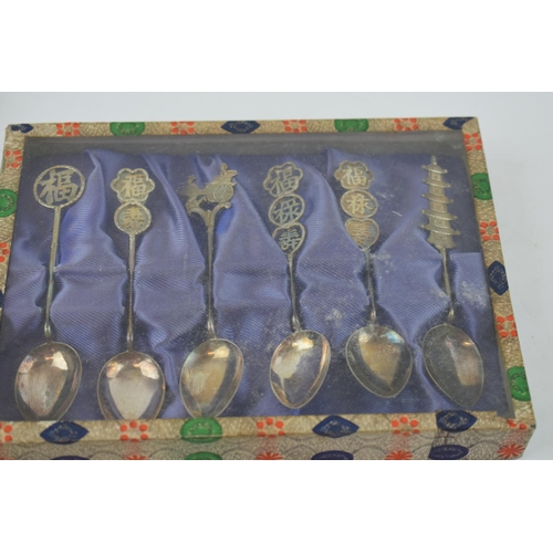 604 - A collection of Chinese silver items to include two sets of six spoons and a cruet set (one hinge af... 