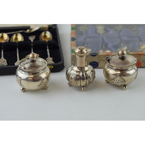 604 - A collection of Chinese silver items to include two sets of six spoons and a cruet set (one hinge af... 