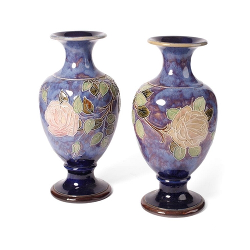 180 - A pair of Royal Doulton stoneware baluster vases with tubelined decoration of roses, on blue backgro... 