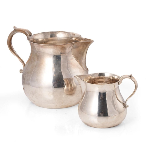 279 - A near graduated pair of silver bulbous jugs, the larger being London 1964, Edward Barnard & Sons, 2... 