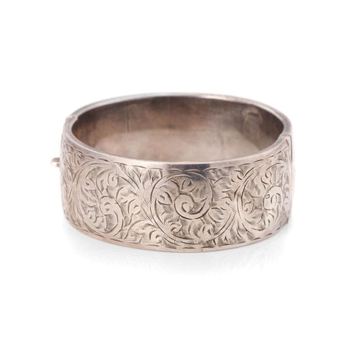 341 - Vintage silver bangle with hand chased repeated design. Weight 35.1 grams.