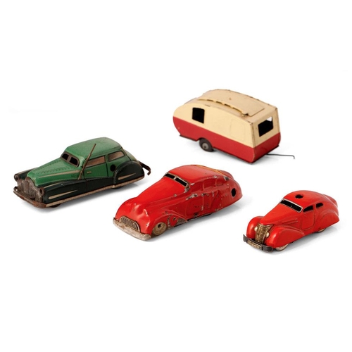 83 - A collection of tin toys and clockwork vehicles to include examples by Tri-ang Minic, Shuco and othe... 