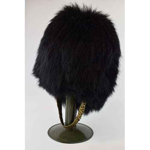 104 - Grenadier Guards Bearskin Headdress on Military Tin Hat Stand dated 1970 with Sam Browne Belt