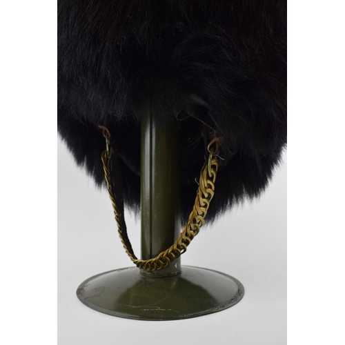 104 - Grenadier Guards Bearskin Headdress on Military Tin Hat Stand dated 1970 with Sam Browne Belt