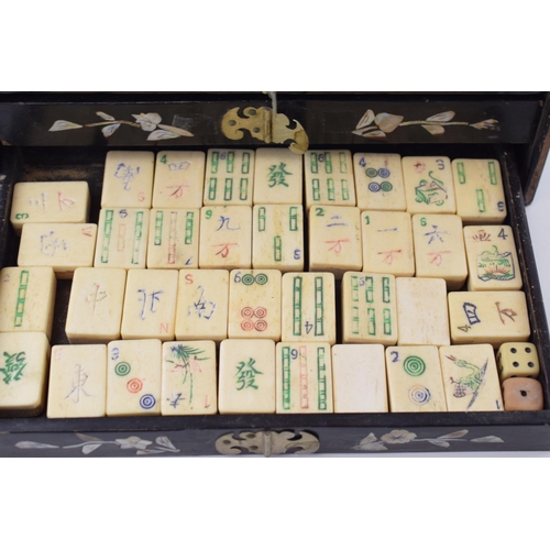 106 - A Mah-Jong set in original lacquered case with mother of pearl inlaid design. Four internal drawers ... 