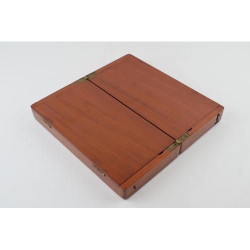 20 - Mahogany cased travel chess set with bone pieces. Case is hinged and folds for transportation.