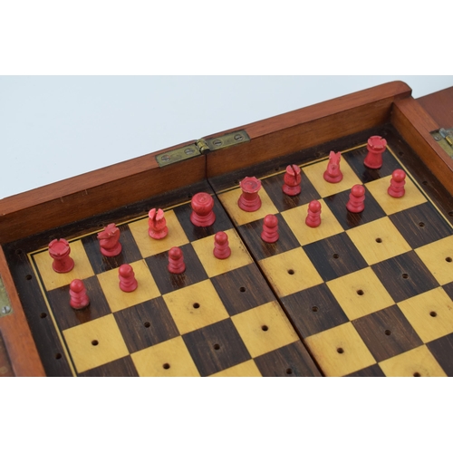 20 - Mahogany cased travel chess set with bone pieces. Case is hinged and folds for transportation.