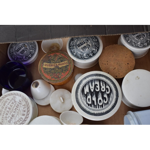 68 - A collection of Victorian and later ceramic advertising pot lids, some with bases, to include Saunde... 