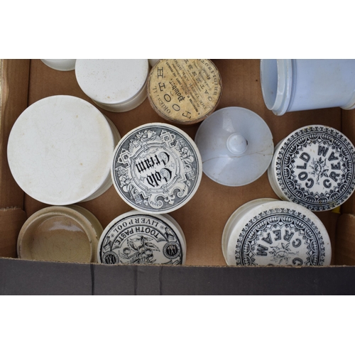 68 - A collection of Victorian and later ceramic advertising pot lids, some with bases, to include Saunde... 