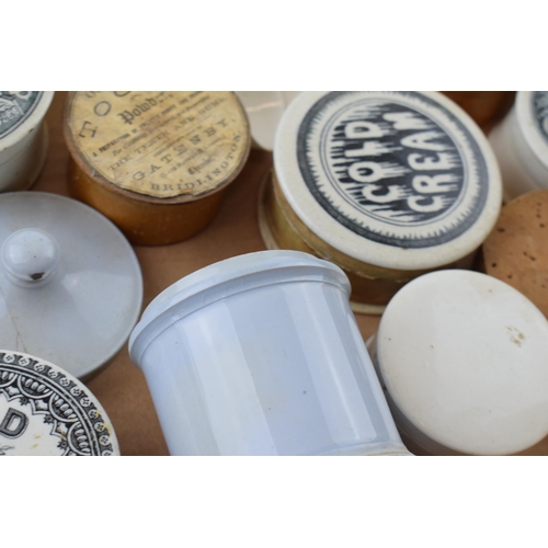 68 - A collection of Victorian and later ceramic advertising pot lids, some with bases, to include Saunde... 