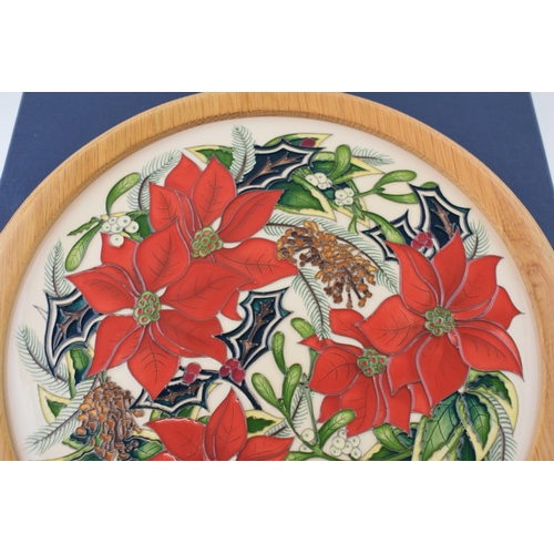 166 - Boxed Moorcroft charger 'Festive Feelings' in light oak frame, signed by Helen Dale, 30.5cm wide.