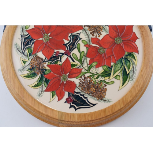 166 - Boxed Moorcroft charger 'Festive Feelings' in light oak frame, signed by Helen Dale, 30.5cm wide.