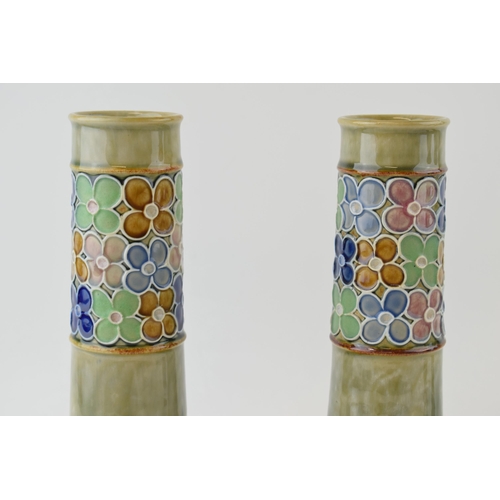 178 - A pair of Royal Doulton Stoneware vases, with stylized flowers, low shouldered, 26cm tall, by Florri... 