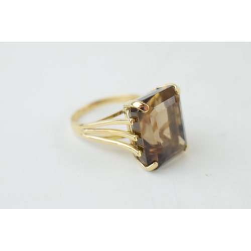 223 - Yellow metal (tests as 14ct or better) ring set with smoky quart stone, size T, gross 10.4g.