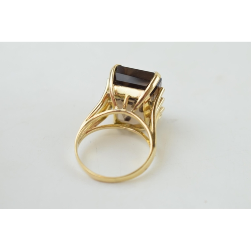 223 - Yellow metal (tests as 14ct or better) ring set with smoky quart stone, size T, gross 10.4g.