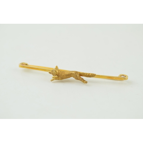 231 - 9ct gold bar brooch with hunting fox, stamped '9ct', 3.8g, 59mm wide.