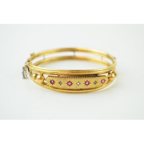 248 - Garnet and Diamond set gold plated Victorian bangle. Four garnets set with three diamonds, safety ch... 