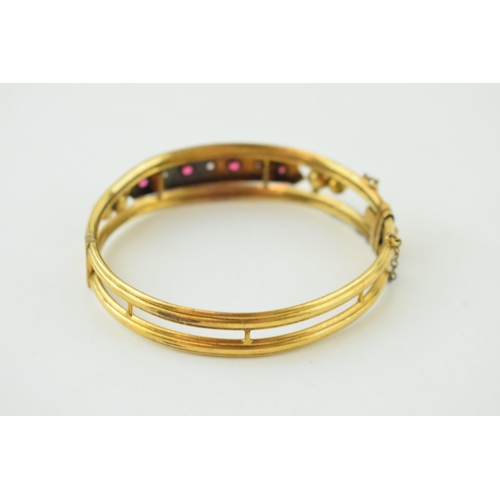 248 - Garnet and Diamond set gold plated Victorian bangle. Four garnets set with three diamonds, safety ch... 