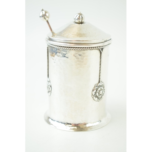 260 - An 'A E Jones' silver preserve pot, hammered effect, with three Tudor rose motifs, ropetwist border,... 