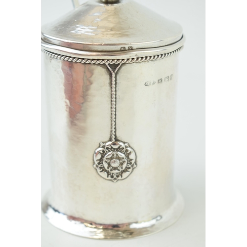 260 - An 'A E Jones' silver preserve pot, hammered effect, with three Tudor rose motifs, ropetwist border,... 