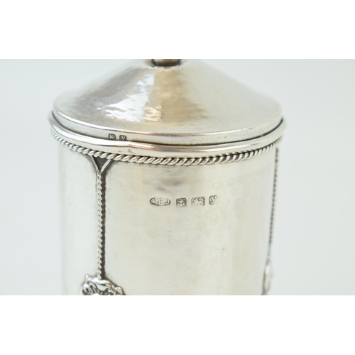 260 - An 'A E Jones' silver preserve pot, hammered effect, with three Tudor rose motifs, ropetwist border,... 