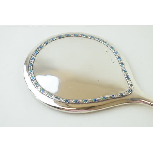 264 - Liberty & Co silver hand mirror, with enamelled decoration on applied foliate border, numbered '5692... 