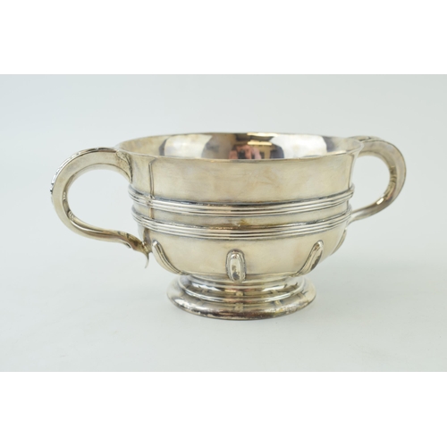 285 - Hallmarked silver twin handled pedestal bowl, with ribbed decoration, large outreaching handles, Lon... 