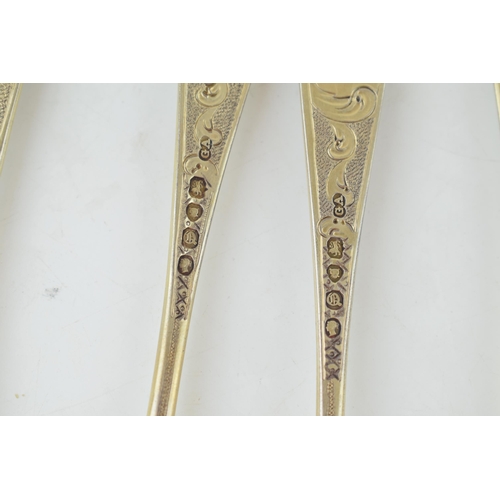 291 - A set of six Victorian silver gilt dessert spoons, with engraved decoration, ornate bowls, four are ... 