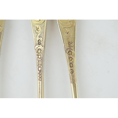 291 - A set of six Victorian silver gilt dessert spoons, with engraved decoration, ornate bowls, four are ... 