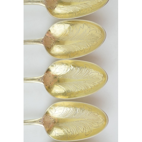 291 - A set of six Victorian silver gilt dessert spoons, with engraved decoration, ornate bowls, four are ... 