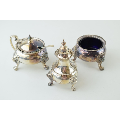 317 - Silver heavy three-piece cruet set, Regency style, with ball and claw feet, lion masks, associated s... 