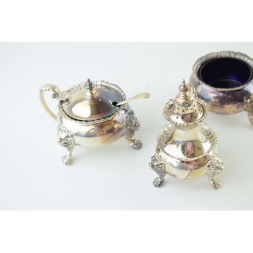 317 - Silver heavy three-piece cruet set, Regency style, with ball and claw feet, lion masks, associated s... 