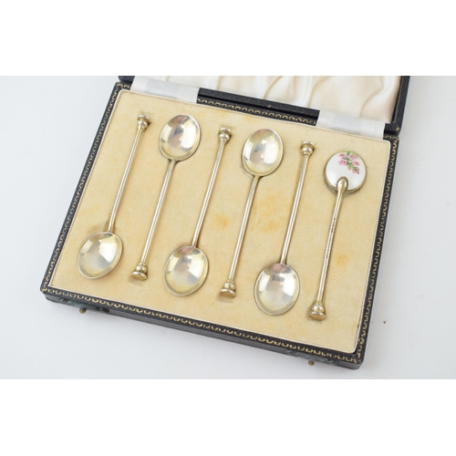 321 - A cased set of six silver tea spoons, with enamelled decoration to rear with floral decoration, 58.4... 