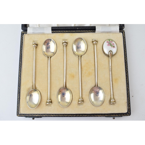 321 - A cased set of six silver tea spoons, with enamelled decoration to rear with floral decoration, 58.4... 