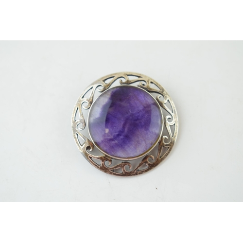 323 - A 'Blue John' brooch with repeated wave design to mount. Marked SIL. Gross weight 12.3 grams.