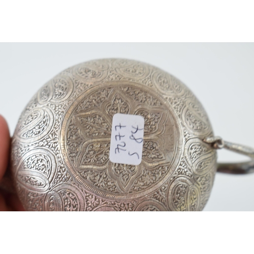 325 - A white metal (tests as sterling silver) ornate pouring jug, heavily engraved decoration, with serpe... 